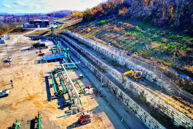 Excavators work along a pipeline construction site