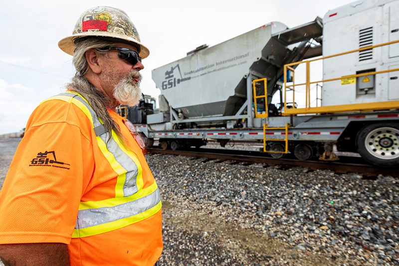 Worker next to railroad.