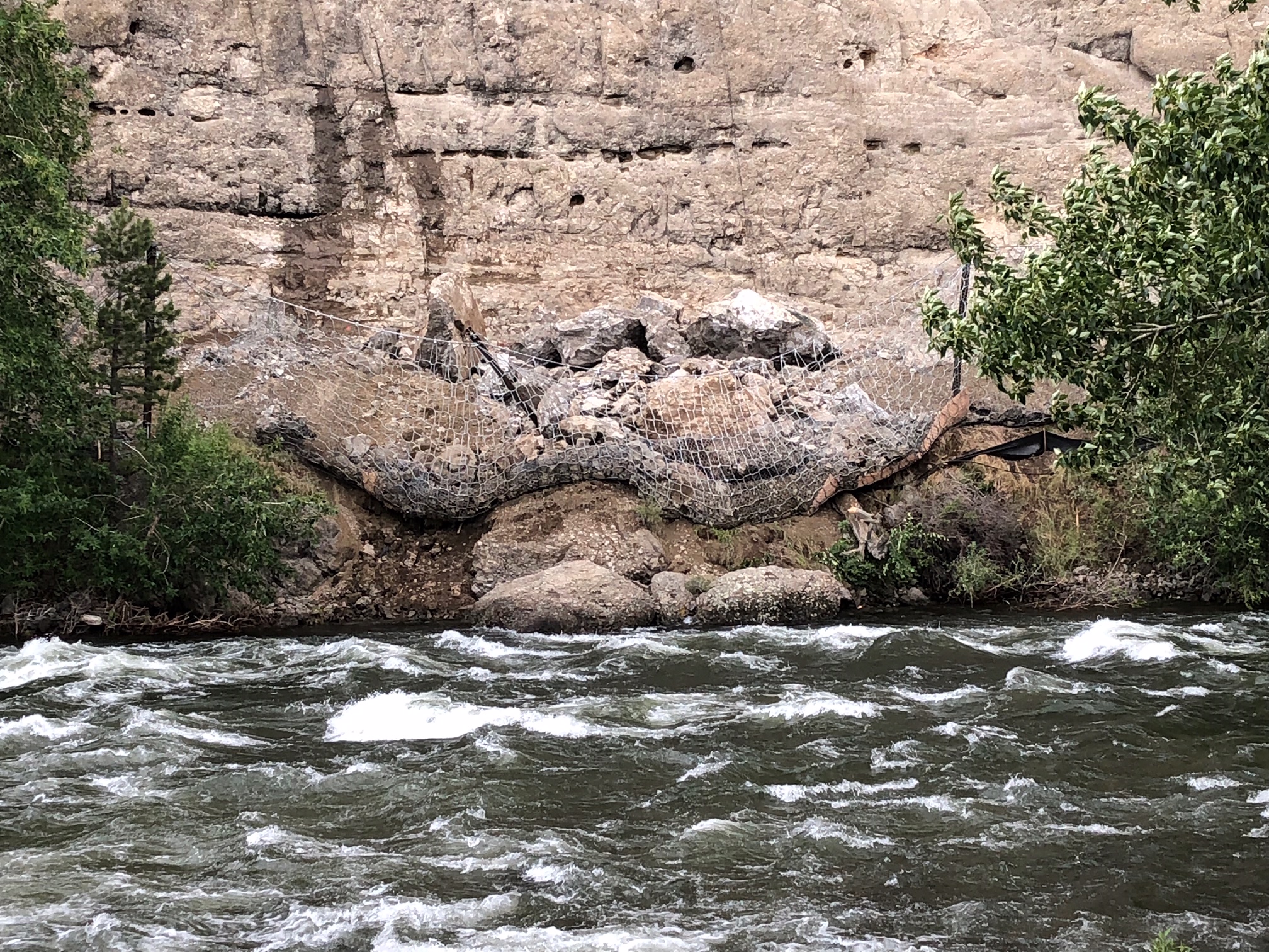 Rockfall barrier full of debris