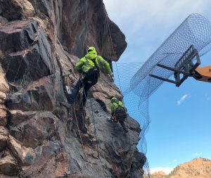People safely scaling rock
