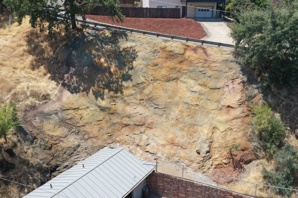 Shotcrete wall with a simple geologic finish in earth tones.