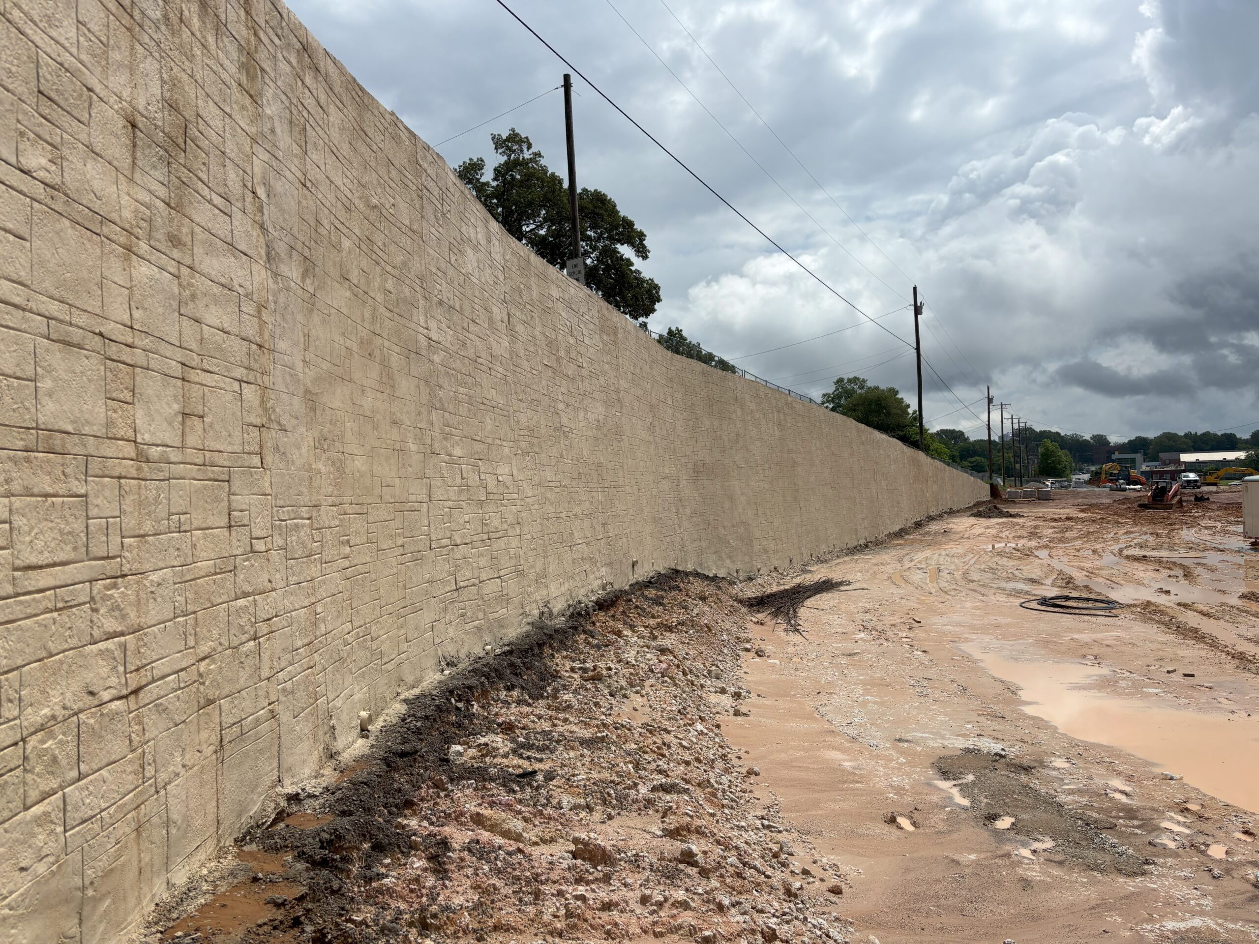 Shotcrete wall with stamped ashlar stone finish.
