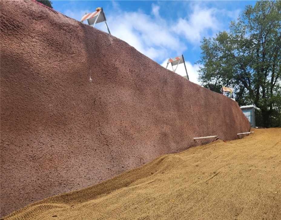 Shotcrete wall with red stain finish.
