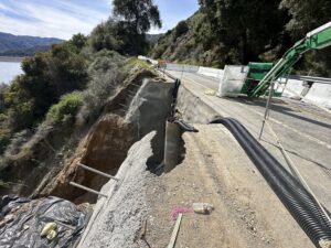 Roadway repair underway on a steep slope.