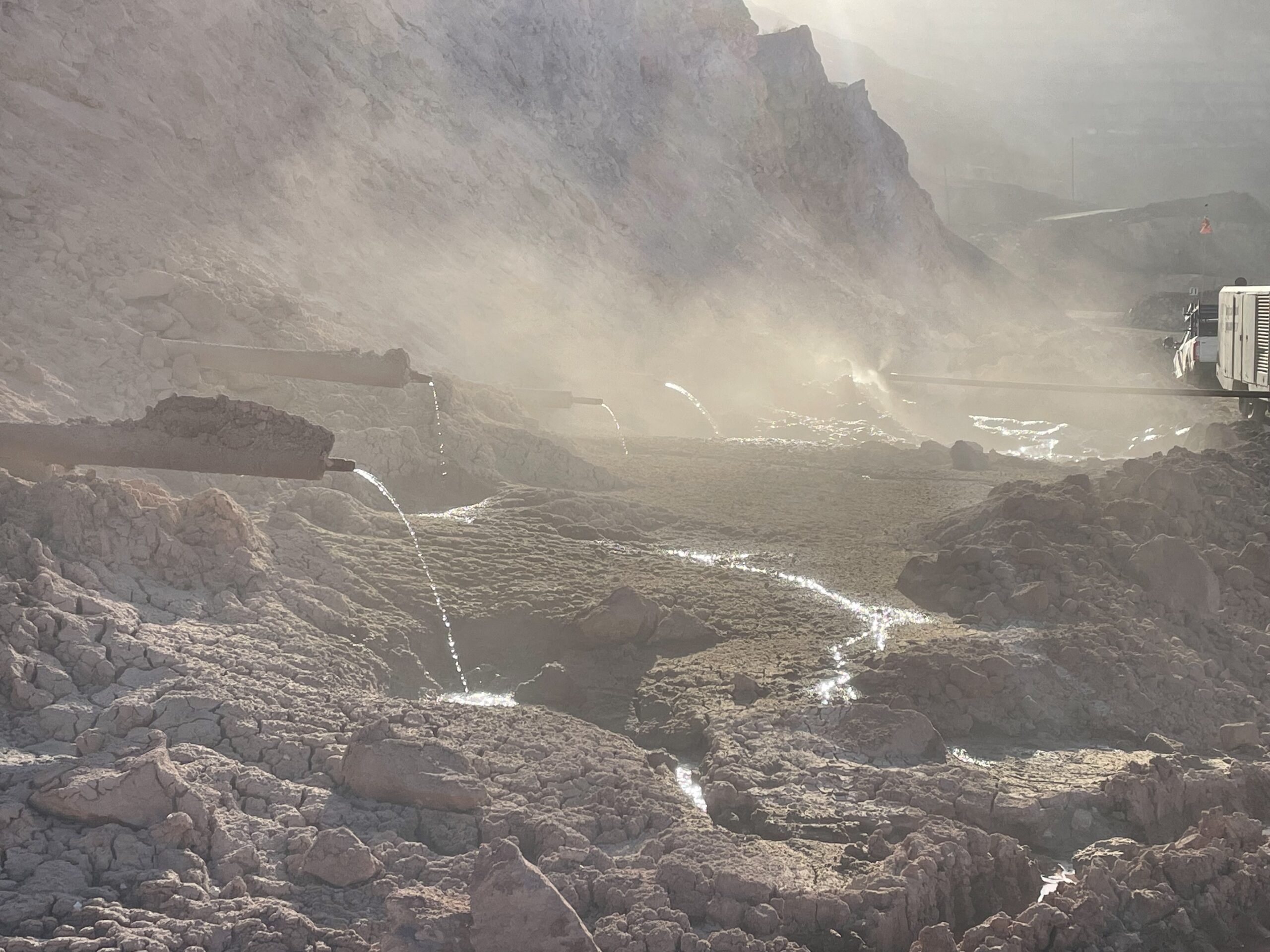 Multiple launched horizontal drains with water draining out.