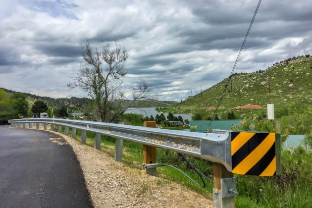 W-beam guardrail installation on highway shoulder