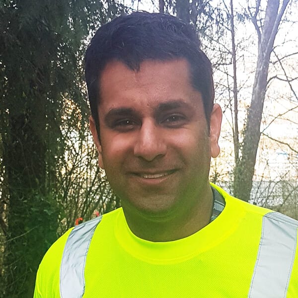 Man smiling in construction vest.