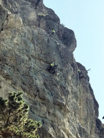 Workers on side of mountain