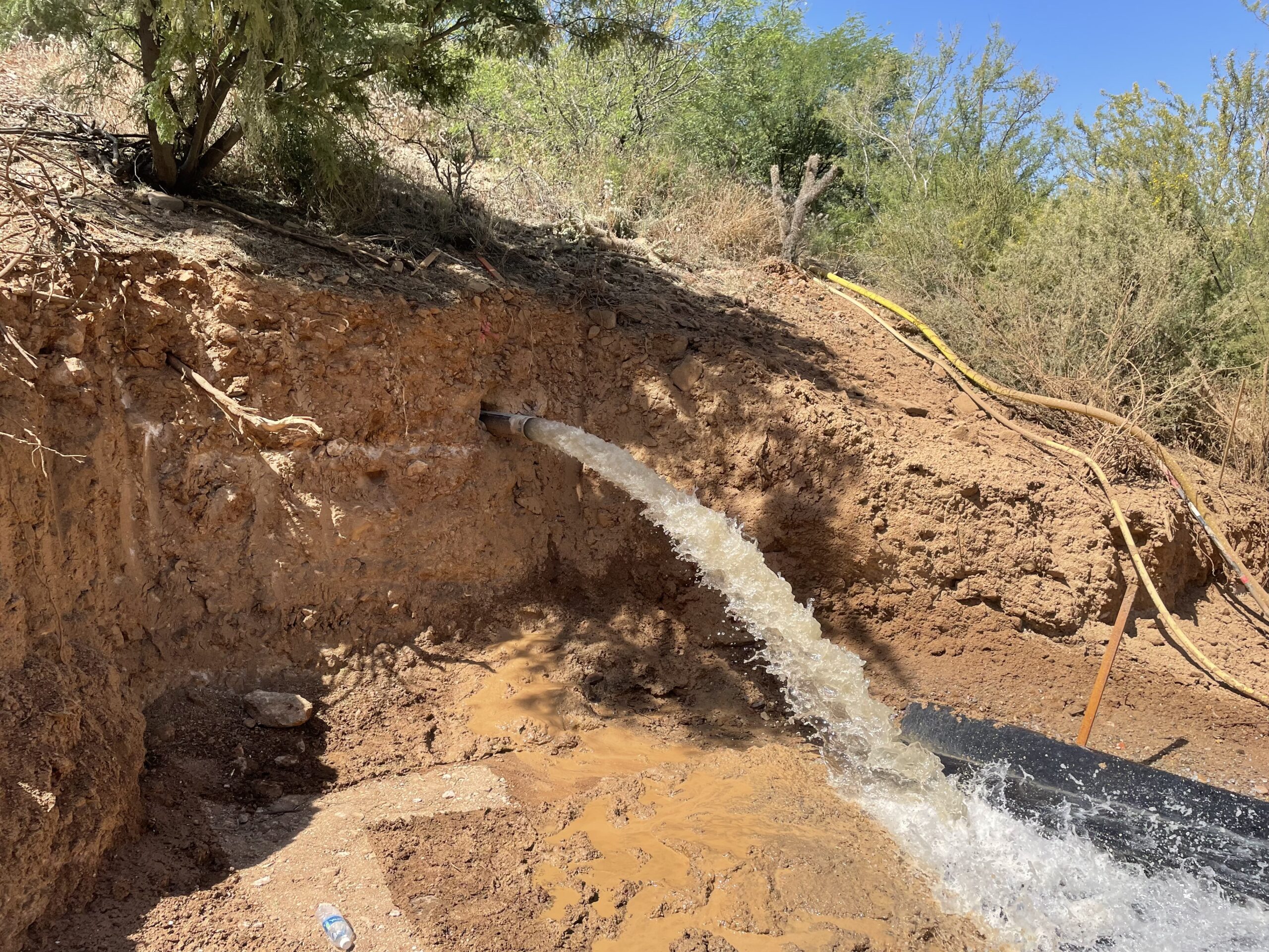 Launched horizontal drain with water draining out.