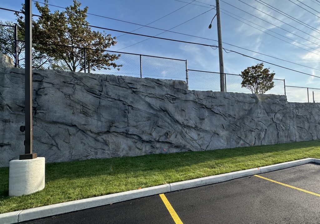 Detailed geologic finish shotcrete wall designed with realistic rock-like textures and multiple color tones.